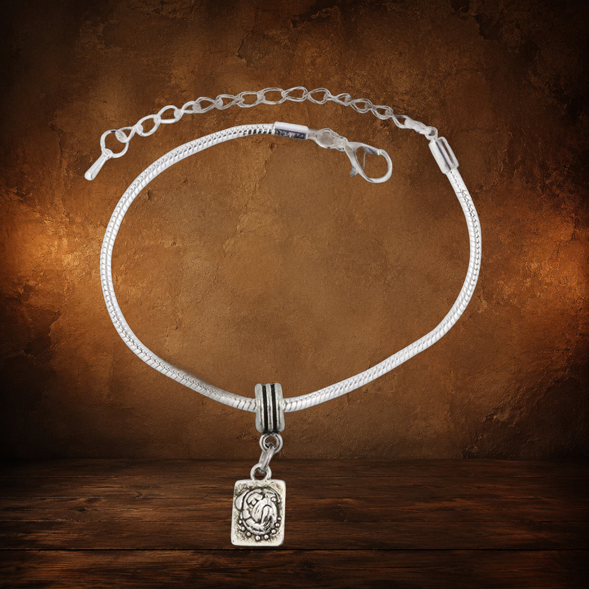 The Pug Devotion Charm Bracelet on an antique Pate’s Pugorium backdrop