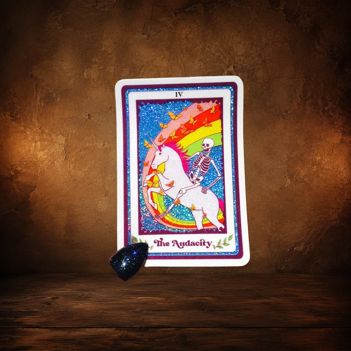 The Audacity Tarot Sticker on an antique Pate’s Pugorium backdrop