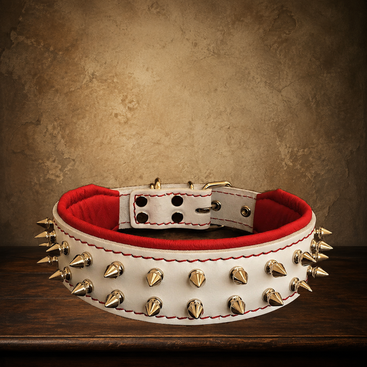 The Ivory Rebel Padded Leather Collar displayed on the approved antique plaster and walnut table