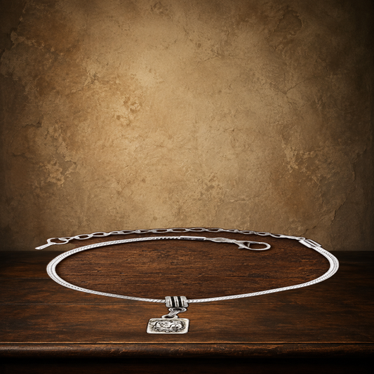 The Pug Devotion Charm Bracelet displayed on the approved antique plaster and walnut table