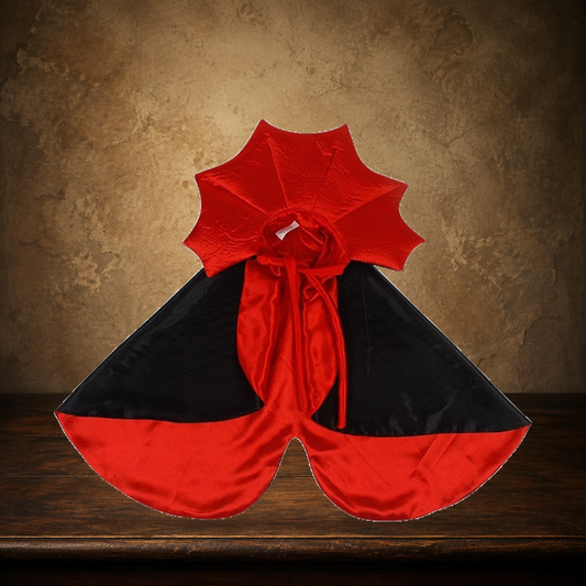 The Little Count Vampire Cloak displayed on the approved antique plaster and walnut table