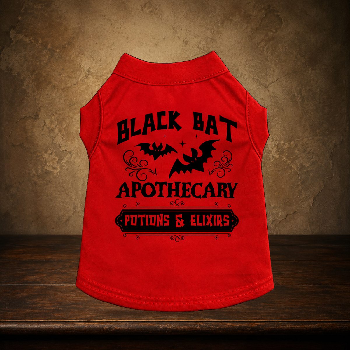 The Traveling Apothecary Potion Pet Shirt displayed on the approved antique plaster and walnut table