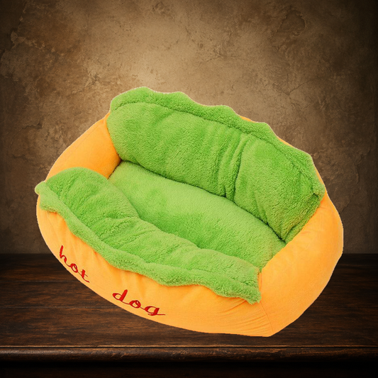 The Frankfurter Fainting Couch — Hot Dog Pet Bed displayed on the approved antique plaster and walnut table