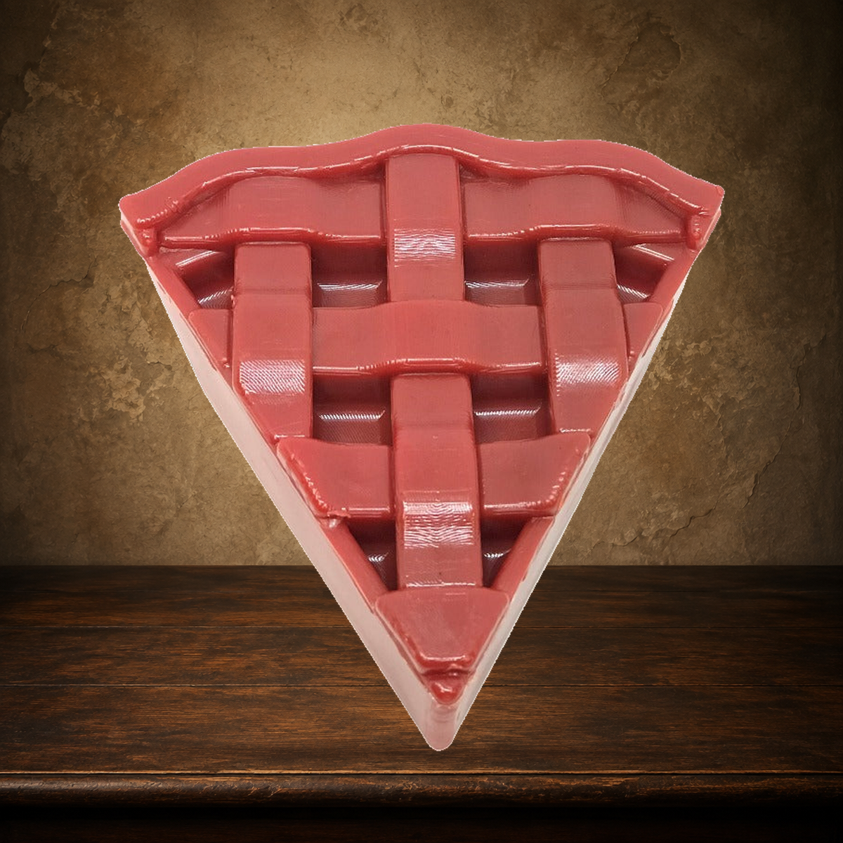 The Forbidden Slice — Cherry Pie Chew Toy displayed on the approved antique plaster and walnut table
