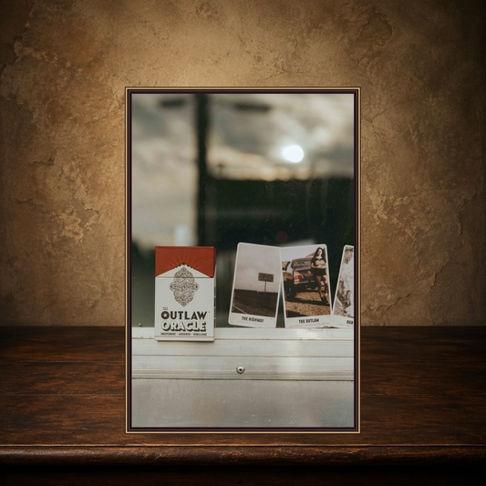 The Outlaw Intuition — Country & Western Oracle Deck displayed on the approved antique plaster and walnut table