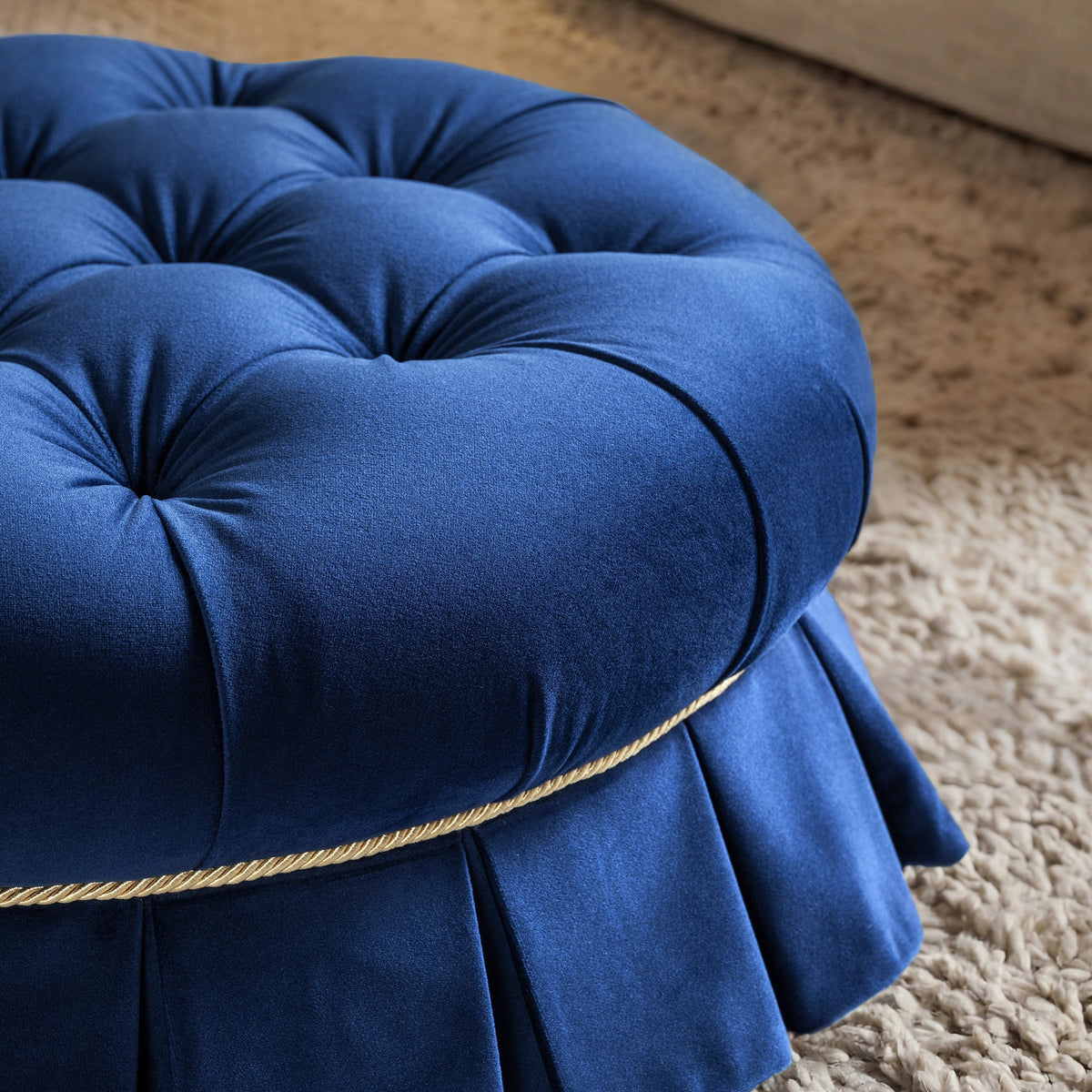 Roquefort Tuffet blue velvet tufting gold cord and pleated skirt detail